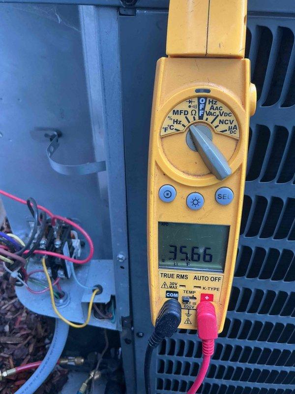 Performed comprehensive cooling system tune-up and maintenance inspection on outdoor air conditioning unit as part of recurring membership agreement. Connected manifold gauges to measure system pressures and verify proper refrigerant charge levels, with readings indicating normal operating parameters across both high and low-side pressures. Utilized digital multimeter to test electrical components, measuring capacitance at 35.66 MFD and verifying proper voltage and amperage at contactor and compressor terminals. All electrical connections were inspected and found secure, with no signs of overheating or deterioration. System operational testing confirmed unit is cooling efficiently and operating within manufacturer specifications.