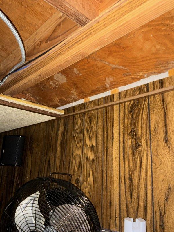 Conducted on-site assessment for new gas line installation to supply fireplace. Evaluated attic space routing options, existing utility pathways, and structural considerations for proper gas piping placement. Documented attic access area showing exposed wooden framing, existing electrical conduits, and available routing corridors for safe gas line installation per code requirements.