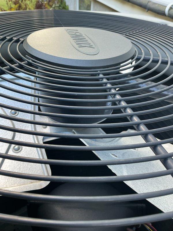 Completed preventative maintenance tune-up on residential air conditioning system. Performed comprehensive inspection of outdoor condenser unit including fan assembly and motor operation, verified proper airflow through protective grill, and measured system temperatures using calibrated digital thermometer, recording supply air temperature of 57.6°F at ductwork. All components found operating within normal parameters with unit showing good overall condition and no visible signs of wear or deterioration.