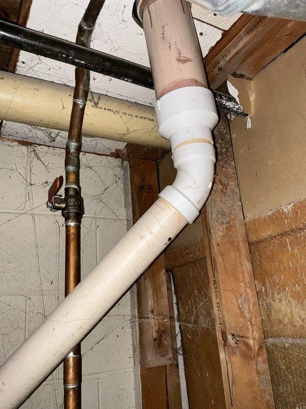 Conducted on-site evaluation of residential water heater experiencing active leak from bottom of unit. Inspected Bradford White water heater installation and confirmed structural failure at tank base, indicating internal corrosion and compromised integrity. Documented existing plumbing configuration including copper supply lines with shutoff valve, PVC drainage system, and current water heater placement in basement utility area. Provided comprehensive replacement estimate for new water heater installation to address failed unit and prevent further water damage.
