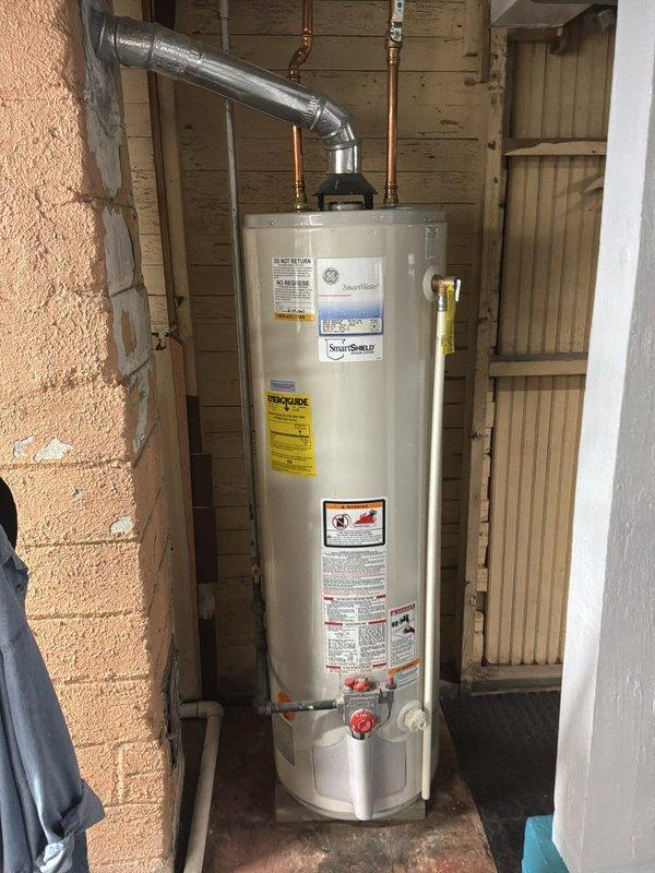 Completed estimate for replacement of existing operational 40-gallon gas gravity water heater. Assessment included documentation of current unit installation in exterior utility enclosure with copper supply lines and proper venting configuration. Provided detailed material specifications for replacement installation including 40-gallon gas gravity water heater, expansion tank with mounting arm, copper press fittings (3/4" couplings, male and female adapters), and copper supply line materials required for code-compliant installation.
