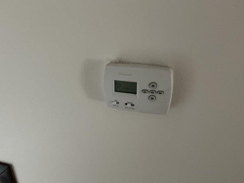 Completed furnace replacement estimate for residential heating system with safety lockout preventing heat operation while air conditioning remains functional. Assessed existing HVAC equipment in basement utility area, documented current thermostat configuration and furnace condition, and provided replacement options to restore safe heating capability to the home.