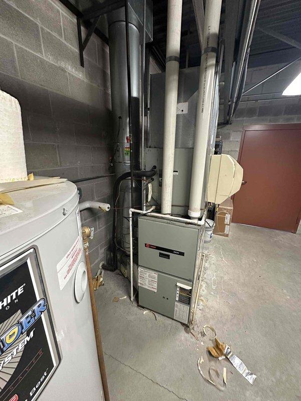 Conducted site assessment for replacement of two commercial air conditioning units. Inspected existing HVAC infrastructure in mechanical room, documented current furnace unit F-1 and associated ductwork configuration. Evaluated equipment accessibility, ductwork connections, and spatial requirements for new AC unit installations. Photographed existing system components and mechanical room layout to prepare comprehensive replacement estimate.