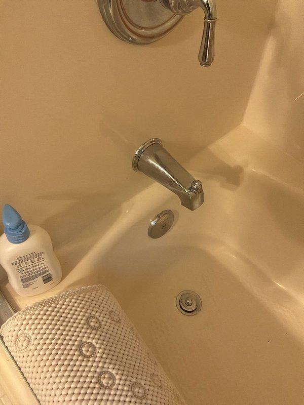 Conducted comprehensive plumbing estimate for three separate issues: sump pump evaluation in basement area with exposed joists and copper piping, replacement assessment for upstairs bathroom tub spout with chrome fixtures and diverter handle, and diagnosis of exterior hose bib leak. Documented existing conditions of all fixtures with photographic evidence for accurate material and labor quotation.
