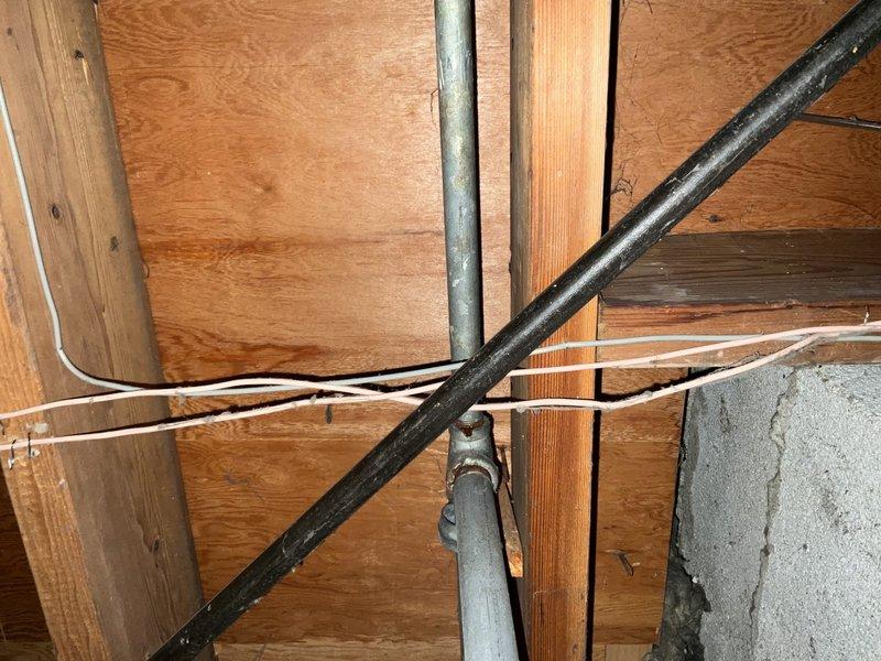 Conducted comprehensive site assessment of ranch-style home with partial finished basement to evaluate feasibility and routing for installation of bedroom return air ducts and first-floor exhaust fan system. Inspected existing ductwork infrastructure, floor joist cavities, and available pathways through basement ceiling space to determine optimal placement for new return air grilles while minimizing structural modifications. Documented current HVAC system configuration including main supply and return trunk lines, noting locations of mechanical equipment and existing utility runs that would impact new ductwork installation. Evaluated basement framing, exposed joists, and wall cavities to plan efficient routing that would accommodate proper return air flow while avoiding conflicts with existing plumbing, electrical conduit, and structural members. Assessed accessibility for installation of first-floor exhaust fan including potential mounting locations, exterior venting pathways, and ele