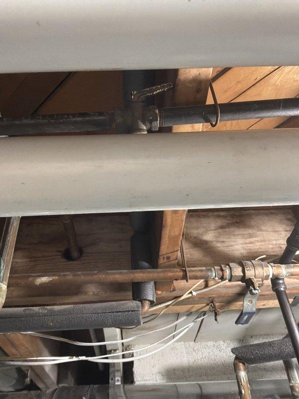 Conducted on-site evaluation for water softener installation in residential property with existing water treatment infrastructure. Assessed current plumbing configuration in crawl space and basement utility area, including copper supply lines, drainage systems, and existing Sterling Water Systems reverse osmosis filtration unit with wall-mounted pressure tank. Documented existing two-tank water treatment system setup and available connection points for proposed water softener integration with current HVAC equipment and water heater installations.