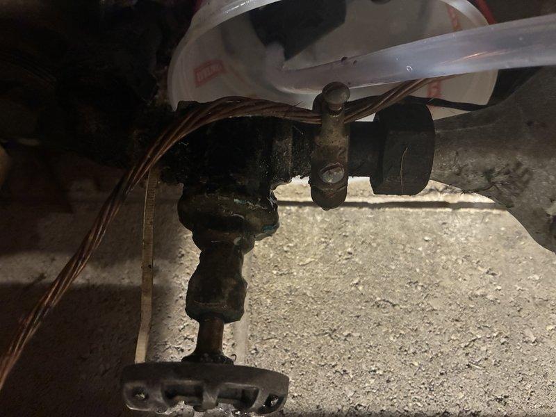 Responded to service call for leaking main shut off valve at property entrance. Upon arrival, water supply was already shut off as reported. Conducted thorough diagnostic inspection of the main shut off valve assembly and discovered severe corrosion and deterioration of the existing valve and associated piping. The valve showed extensive rust damage with flaking metal surfaces, indicating prolonged exposure to moisture and age-related failure. Valve mechanism was compromised beyond repair due to corrosion. Documented existing conditions with photographic evidence showing the corroded valve assembly, connecting pipes, and surrounding plumbing infrastructure in the crawl space area. Assessed the valve's condition and determined replacement would be necessary to restore proper function and prevent future leaks. Provided findings and recommendations for valve replacement to restore water service safely.