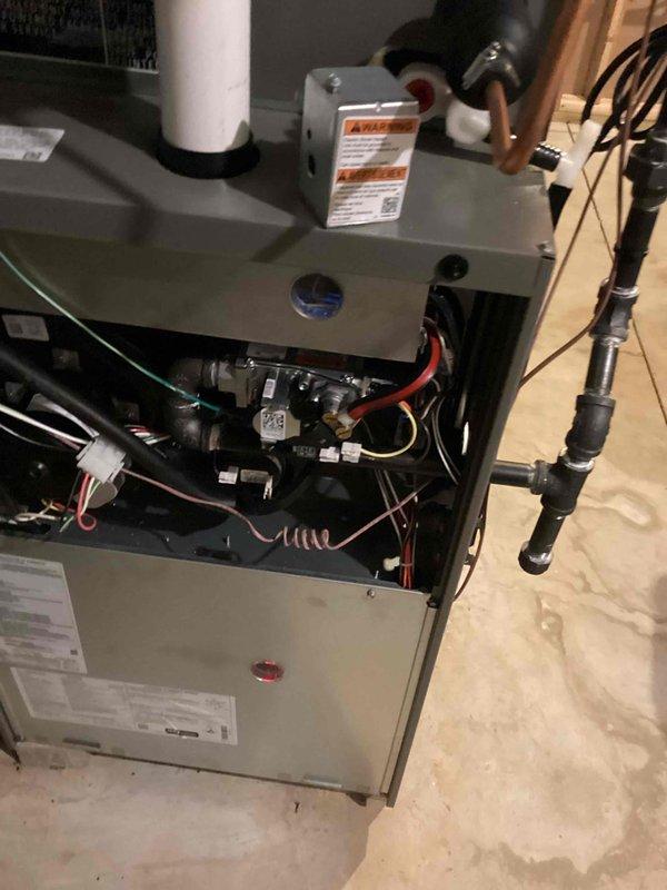 Completed full HVAC system installation including furnace, air conditioning unit, and humidifier with all required permits and electrical work. Installed new furnace in basement/utility area with PVC venting, condensate drain system, and proper electrical connections to control boards and safety devices. Set up outdoor AC condenser unit with refrigerant line connections, charged system to manufacturer specifications using manifold gauges, and installed condensate pump at exterior foundation. All equipment tested and operational upon completion.