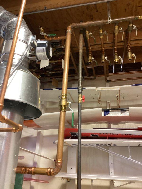 Completed comprehensive tune-up service on residential boiler system and mini-split unit. Inspected hydronic heating distribution manifold with multi-zone brass ball valves, verified circulator pump operation (Taco 007 model), examined copper piping connections and flexible ductwork throughout mechanical room, and documented system configuration with all components functioning properly.