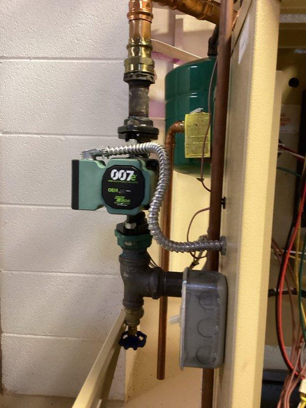 Completed comprehensive tune-up service on residential boiler system and mini-split unit. Inspected hydronic heating distribution manifold with multi-zone brass ball valves, verified circulator pump operation (Taco 007 model), examined copper piping connections and flexible ductwork throughout mechanical room, and documented system configuration with all components functioning properly.