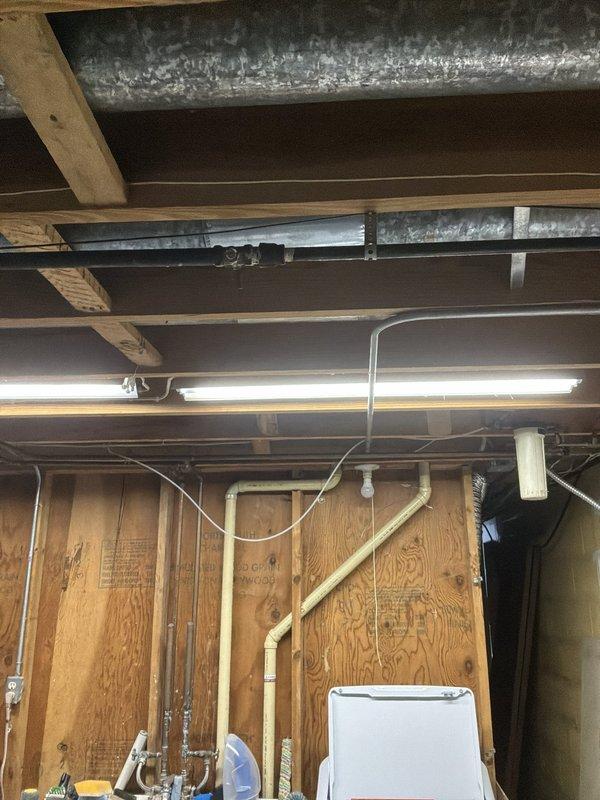 Completed estimate for new gas line installation to serve kitchen stove in basement utility area. Assessed existing gas piping configuration and determined routing requirements for rerouting current line and installing new dedicated gas supply line for stove connection. Documented existing conditions including exposed ceiling joists, HVAC ductwork, and current utility piping layout to plan optimal path for new black iron gas pipe installation that will meet code requirements and provide proper gas supply to appliance location.
