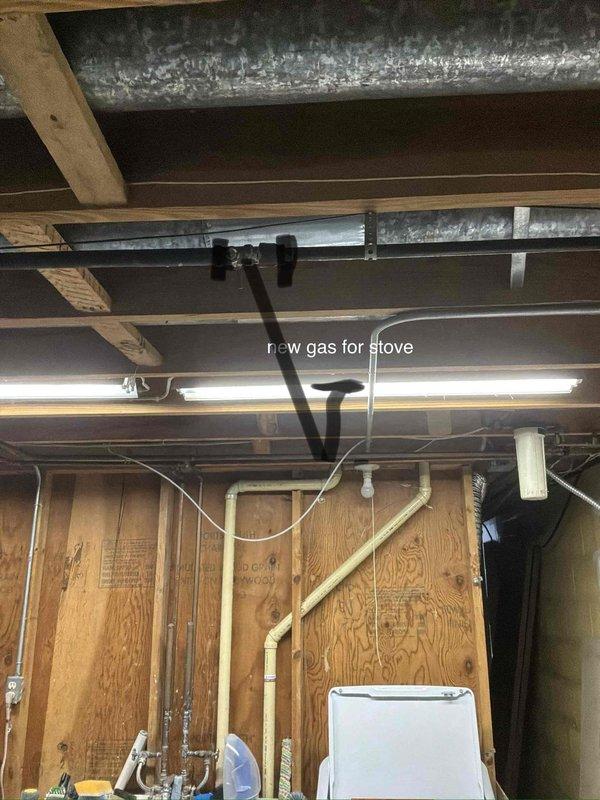 Completed estimate for new gas line installation to serve kitchen stove in basement utility area. Assessed existing gas piping configuration and determined routing requirements for rerouting current line and installing new dedicated gas supply line for stove connection. Documented existing conditions including exposed ceiling joists, HVAC ductwork, and current utility piping layout to plan optimal path for new black iron gas pipe installation that will meet code requirements and provide proper gas supply to appliance location.