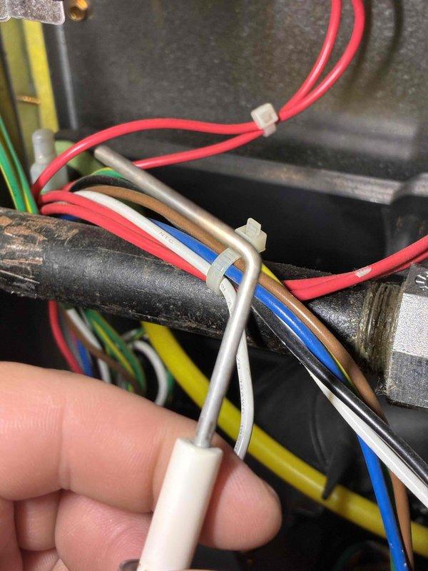 Responded to service alert from thermostat indicating unit required maintenance. Performed comprehensive tune-up on HVAC system, inspecting electrical connections, wiring integrity, and component condition. Observed deteriorated insulation on refrigerant line requiring attention and documented existing wire management with bundled connections secured along infrastructure. Reset thermostat service alert and updated maintenance schedule to reflect correct service interval date for future notifications.