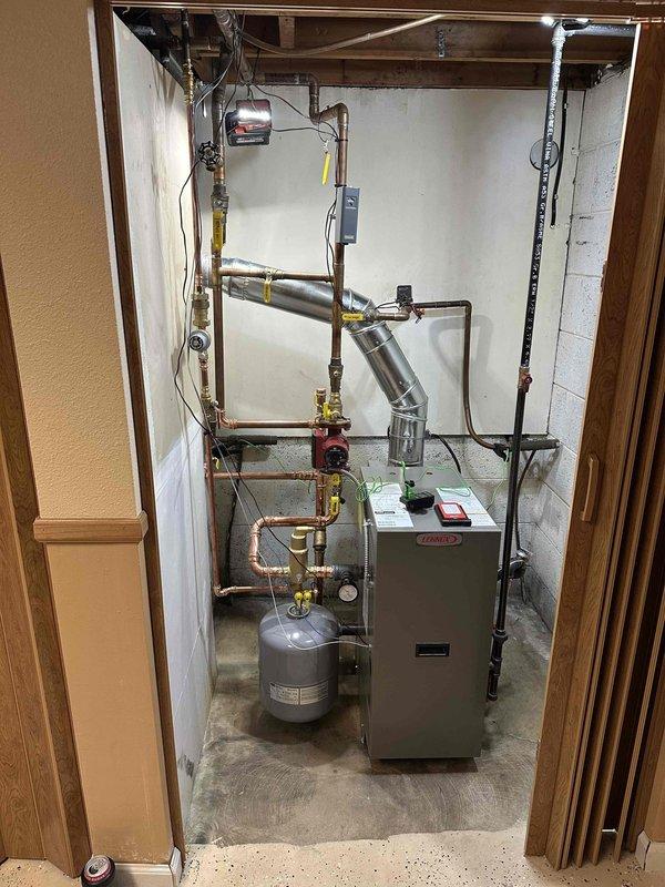 Completed installation of 80% efficiency boiler system with full permit compliance and coordinated trades. Installation included new copper supply and return piping with brass isolation valves, integration with existing expansion tank, and connection to water heater system. Coordinated with licensed electrician for all electrical connections and power requirements. Milwaukee Chimney installed new 5" stainless steel liner for proper venting per manufacturer specifications. All piping secured and supported to code, system tested for leaks, and unit commissioned successfully with proper combustion analysis and safety checks verified.