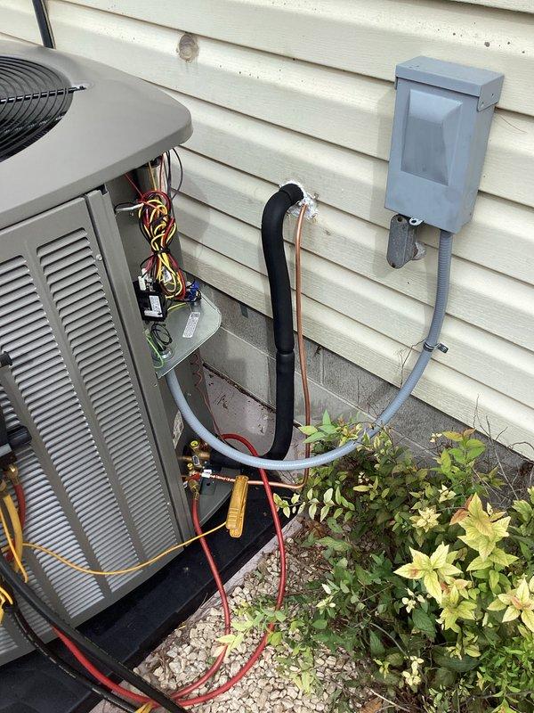 Completed full HVAC system installation including new furnace and air conditioning unit. Installed gas furnace with all electrical connections, control boards, and gas valve assembly properly wired and secured within cabinet enclosure. Mounted outdoor AC condenser unit on concrete pad with proper refrigerant line connections using insulated and copper lines. Installed electrical disconnect box on exterior with conduit routing to unit. All wiring completed to code specifications with licensed electrician on site. System tested and operational upon completion.