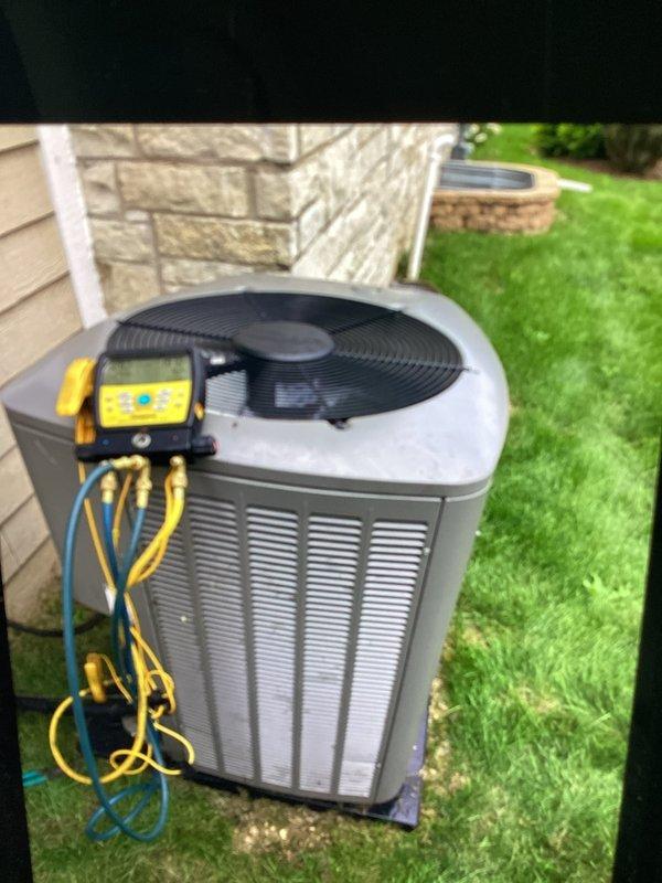 Performed comprehensive tune-up on residential air conditioning system, including refrigerant pressure and temperature diagnostics using digital manifold gauge set. System readings confirmed proper superheat and subcooling levels, with left side showing 12.8 PSIG at 41.1% saturation and right side reading 191.7 PSIG at 88.8% saturation, indicating normal operating parameters for the outdoor condensing unit.