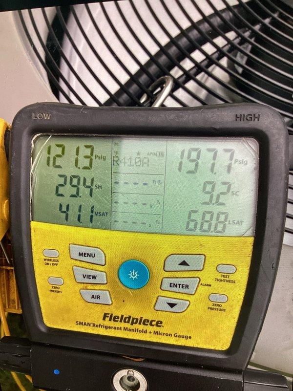 Performed comprehensive tune-up on residential air conditioning system, including refrigerant pressure and temperature diagnostics using digital manifold gauge set. System readings confirmed proper superheat and subcooling levels, with left side showing 12.8 PSIG at 41.1% saturation and right side reading 191.7 PSIG at 88.8% saturation, indicating normal operating parameters for the outdoor condensing unit.