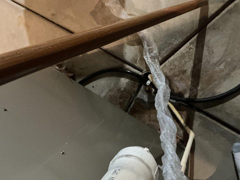 Conducted furnace replacement estimate in unfinished basement area with exposed joists and existing HVAC infrastructure. Evaluated current system configuration, assessed available utility connections including existing PVC venting and electrical conduit, and provided equipment replacement recommendations to homeowner and family representative.