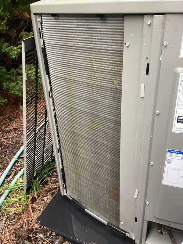 Completed comprehensive furnace and air conditioning tune-up service including full system inspection and air distribution adjustment. Accessed outdoor condensing unit, identified and replaced heavily soiled air filter that was densely packed with dust, dirt, and debris causing restricted airflow. Inspected condenser coil fins, electrical connections, and overall unit operation to ensure optimal system performance.