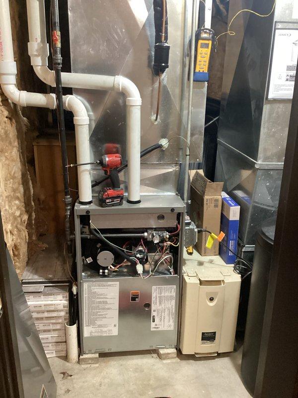 Completed furnace tune-up and system inspection on residential HVAC unit. Performed comprehensive maintenance including visual inspection of internal components, blower motor assembly, and electrical connections with furnace access panel opened for thorough examination. Verified proper operation of condensate drain system and PVC venting configuration, checked all mechanical components for wear and proper function, and confirmed system is operating within manufacturer specifications.