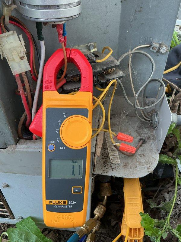 Completed routine A/C tune-up and maintenance inspection as part of prepaid membership service. Performed system diagnostics on outdoor condensing unit, including electrical testing with clamp meter to verify proper amperage draw and capacitor functionality. Inspected unit condition, noting rust and corrosion on protective grille and accumulated debris on condenser coils, though system operational parameters remained within acceptable limits for continued service.