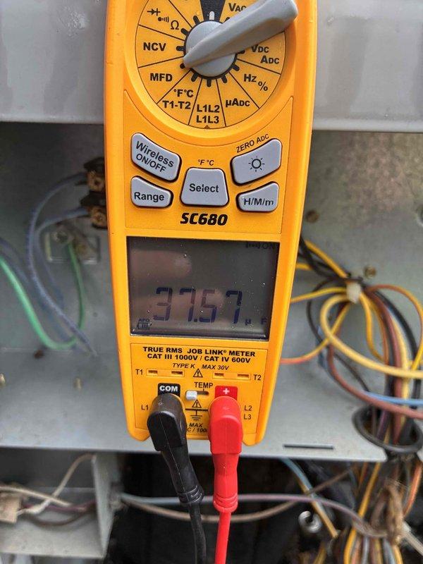 Completed furnace tune-up and air conditioning tune-up on residential HVAC system. Performed comprehensive diagnostics including temperature measurements of heat exchanger components registering 588°F and electrical testing showing 3769 microfarads capacitance reading using calibrated multimeter. Inspected all system components, verified proper operation of both heating and cooling units, and documented equipment conditions through thermal and electrical analysis.