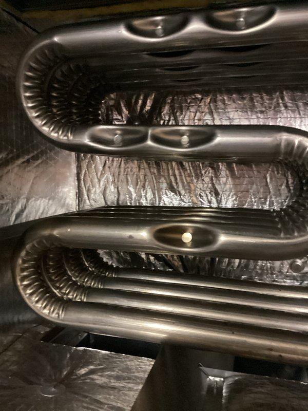 Completed heating tune-up service on MagicPak HVAC unit. Replaced thermostat batteries, installed new air filter, and performed system inspection with multimeter testing to verify proper electrical operation and heating functionality.