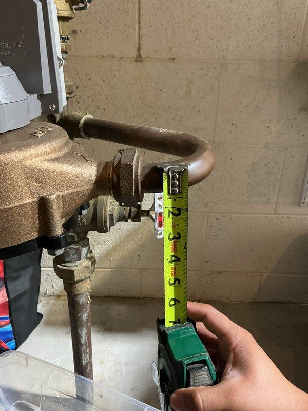 Responded to water main leak in basement utility area. Conducted thorough inspection of copper pipe assembly and brass valve system connected to water meter. Documented precise measurements of existing piping configuration to determine correct replacement parts needed. Assessed condition of corroded brass fittings and aging copper pipes showing significant patina and wear. Prepared specifications for parts ordering and developed comprehensive repair estimate for water main leak remediation.