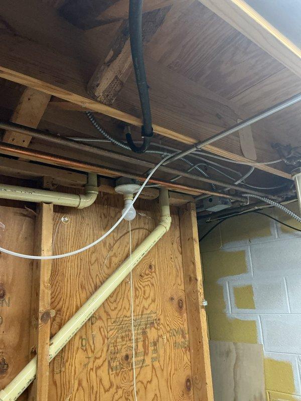 Installed new gas line routing through floor joists and crawl space area per approved estimate. Gas line was properly secured to structural framing with appropriate mounting brackets and run horizontally through existing utility space alongside other building infrastructure. Installation included brass shut-off valve with red handle for system isolation and safety control. All piping was installed in compliance with gas code requirements, properly supported at required intervals, and positioned to avoid interference with existing plumbing, electrical conduit, and HVAC systems in the area. Gas line terminates at wall penetration with secure mounting and appropriate insulation protection where needed.