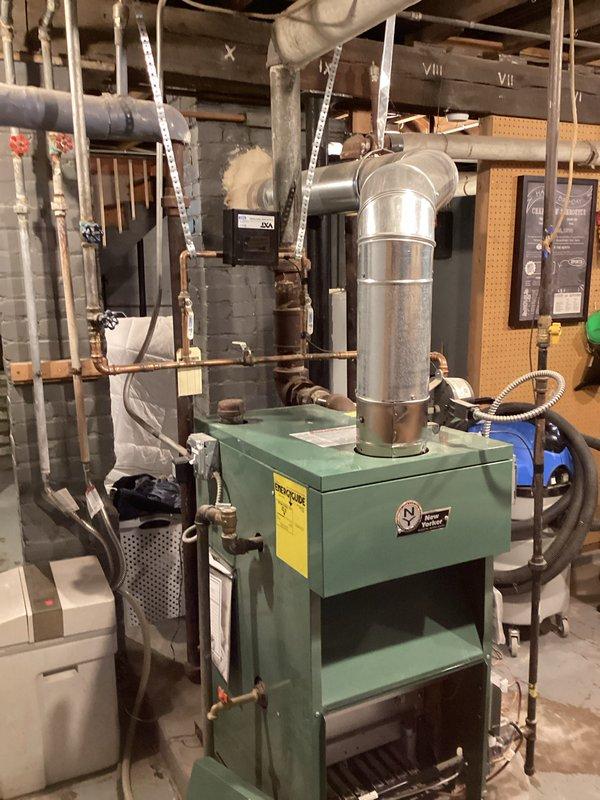 Performed comprehensive tune-up and maintenance on mid-efficiency chimney-vented boiler system. Disassembled, cleaned, and inspected burner assembly tubes and components, removing carbon deposits and verifying proper combustion chamber condition. Reassembled system, tested all safety controls, verified proper venting operation, and confirmed efficient heating system performance upon completion.