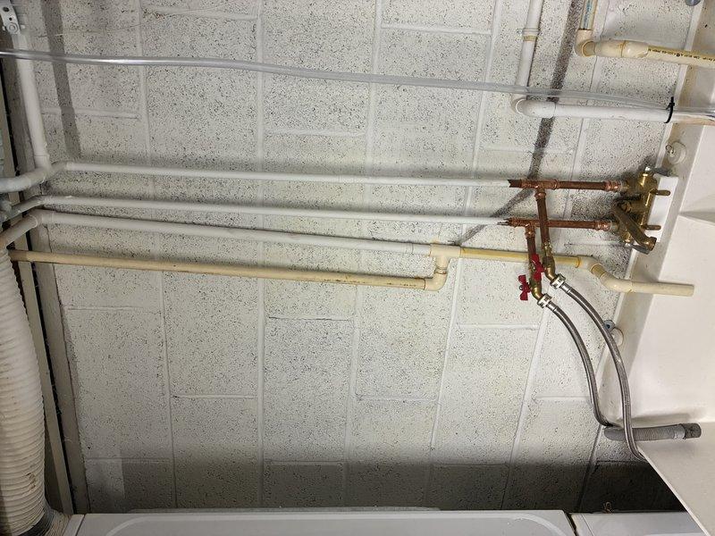 Installed a 32,000 grain capacity water softener system in the mechanical room. Connected the unit to existing copper supply lines using brass fittings and valves, integrated the system with the home's main water distribution network, and verified proper operation of all inlet and outlet connections.