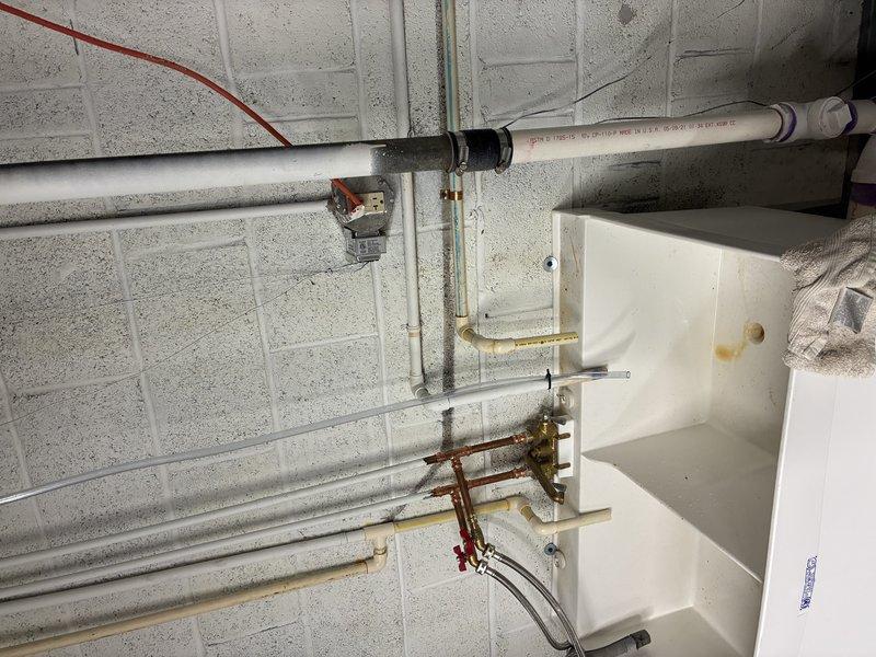 Installed a 32,000 grain capacity water softener system in the mechanical room. Connected the unit to existing copper supply lines using brass fittings and valves, integrated the system with the home's main water distribution network, and verified proper operation of all inlet and outlet connections.