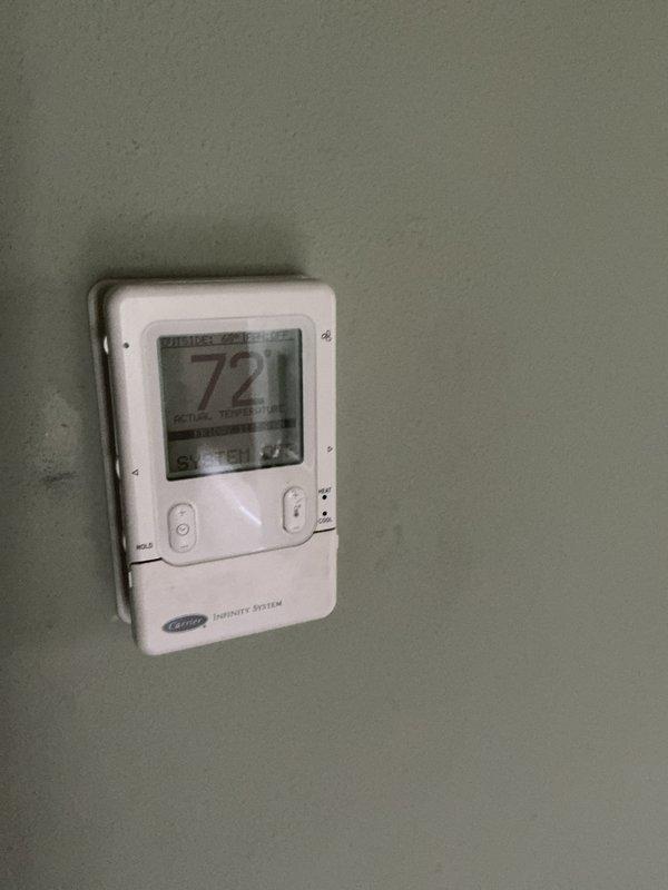 Provided estimate for complete furnace replacement system. Current furnace operational but experiencing temperature fluctuation issues and difficulty maintaining setpoint temperature. Documented existing Carrier Infinity System thermostat and basement installation location with exposed ductwork and PVC piping during assessment.