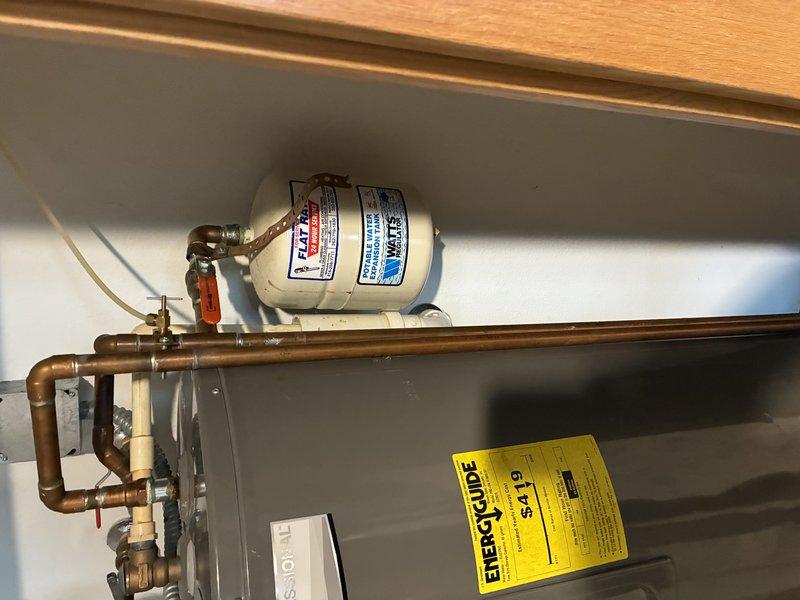 Responded to water heater leak emergency and completed full tanked water heater replacement. Removed failed unit and installed new tanked water heater with proper copper and CPVC supply line connections, including necessary brass fittings and compression joints. Installed shutoff valve with red handle for system isolation, verified all connections for proper seal integrity, and confirmed unit operation with no active leaks upon completion.
