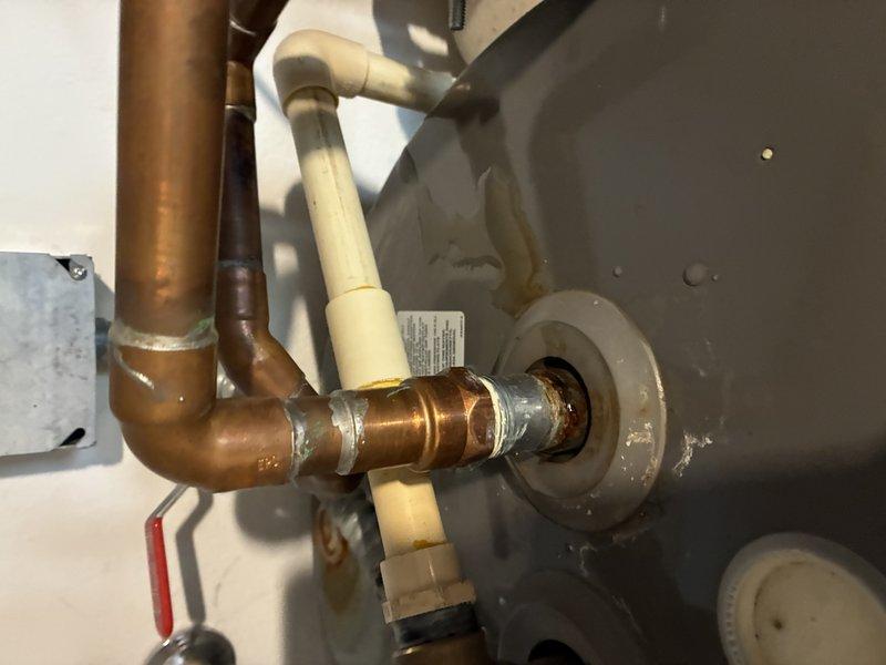 Responded to water heater leak emergency and completed full tanked water heater replacement. Removed failed unit and installed new tanked water heater with proper copper and CPVC supply line connections, including necessary brass fittings and compression joints. Installed shutoff valve with red handle for system isolation, verified all connections for proper seal integrity, and confirmed unit operation with no active leaks upon completion.
