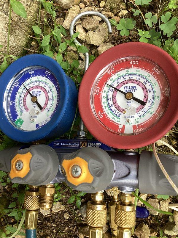 Completed preventive maintenance tune-up on outdoor air conditioning condenser unit. Connected manifold gauge set to measure refrigerant pressures and verify system operating parameters within manufacturer specifications. Inspected refrigerant lines, electrical connections, and overall unit condition during service call.