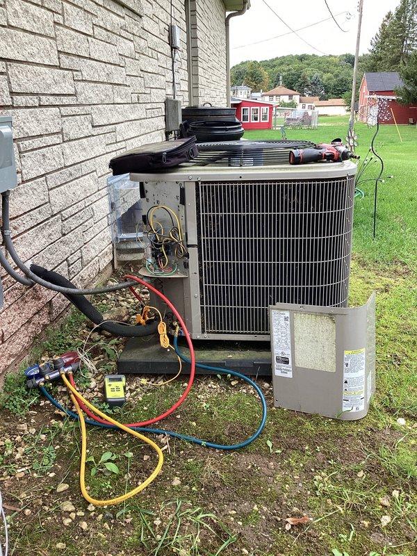 Completed preventive maintenance tune-up on outdoor air conditioning condenser unit. Connected manifold gauge set to measure refrigerant pressures and verify system operating parameters within manufacturer specifications. Inspected refrigerant lines, electrical connections, and overall unit condition during service call.