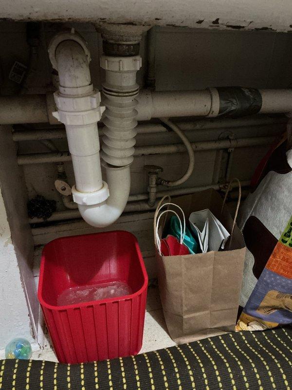 Responded to emergency call for water leaking through ceiling and addressed slow-draining bathroom sink. Inspected under-sink plumbing and P-trap assembly, cleared drainage obstruction, and verified proper flow restoration. Additionally provided estimate for sump pump and utility sink installation in basement utility area where existing plumbing infrastructure was assessed.