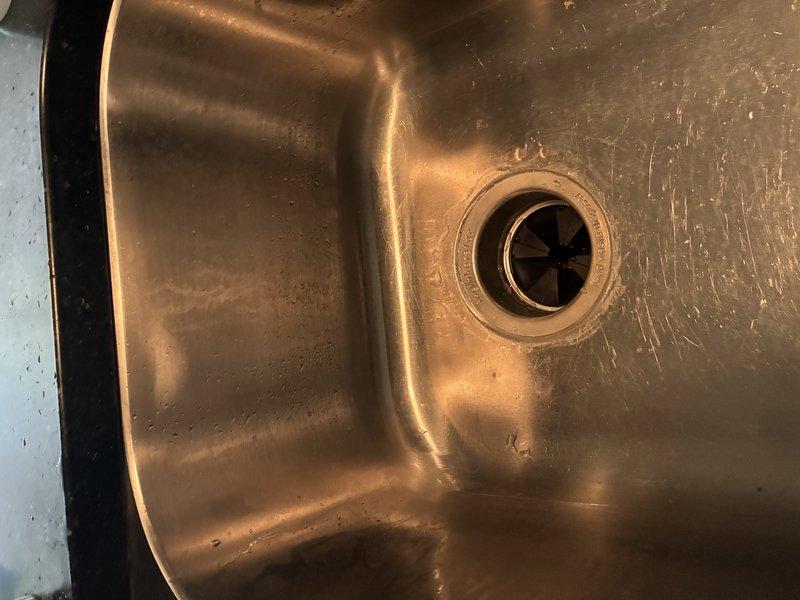 Installed new garbage disposal unit under kitchen sink. Connected disposal to existing drain assembly and PVC P-trap plumbing system. Secured all plumbing connections and verified proper drainage flow. Installation completed successfully with disposal unit operational and tested for functionality.