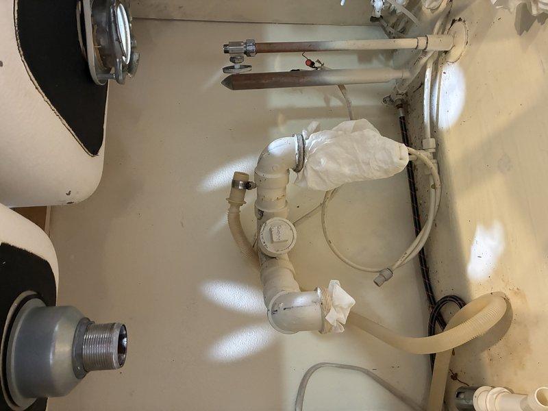 Disconnected kitchen sink, garbage disposal, and stove in preparation for new countertop installation. All plumbing connections were safely isolated and capped to prevent water damage during the renovation work.
