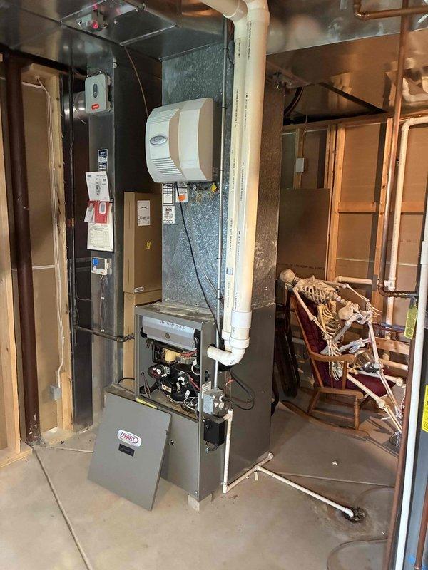 # No Heat Service Call - Furnace 10+ Years Old

Responded to no heat complaint on residential gas furnace system. Upon arrival, accessed basement mechanical room and inspected furnace unit and associated components. Opened electrical compartment and examined control board, wiring connections, and capacitor for signs of failure or damage. Verified all wire connections were secure and checked for proper voltage supply to unit. Inspected gas valve assembly and confirmed proper operation. Examined intake and exhaust PVC venting system for blockages or condensate issues. Checked humidifier operation and water supply line. Restored heat to residence and verified system cycled properly through complete heating operation. System returned to normal function.