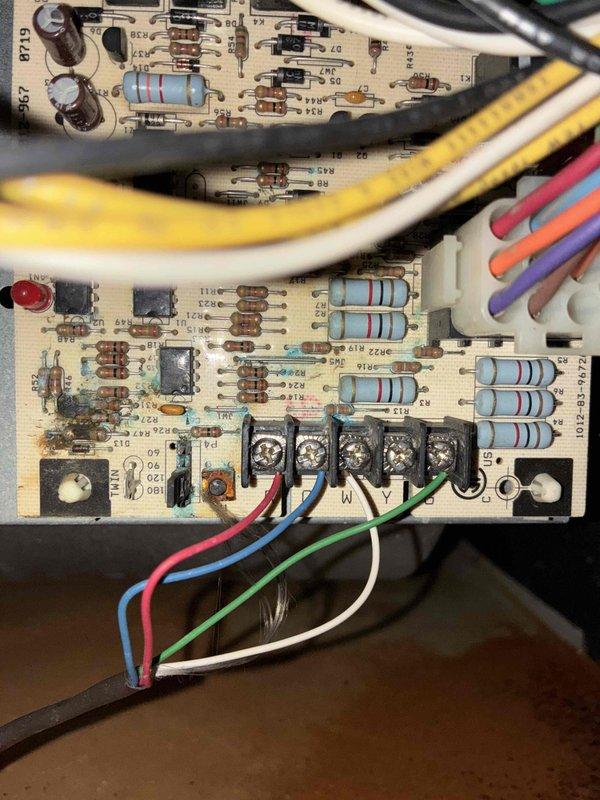 # HVAC No Heat Service Call - 10+ Year Old Unit

Responded to no heat complaint on aging HVAC system. Upon arrival, conducted diagnostic inspection of unit interior and control systems. Accessed main control compartment and evaluated primary and secondary control boards for functionality. Inspected electrical connections, relay terminals, and capacitor components. Observed significant rust deterioration on unit base and interior housing, indicating extended service life and moisture exposure history. Examined wiring harnesses with multiple conductor connections to control board terminal blocks. Verified circuit board components including resistors, capacitors, and relay switches for proper operation. Documented existing condition of control boards showing populated electronic components and connection points. Assessed overall system condition noting age-related wear patterns consistent with 10+ year old equipment. Photographed control board assembly and interior compartment for service
