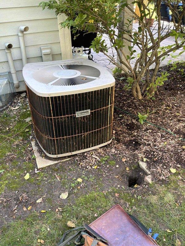 Provided comprehensive estimate for complete HVAC system replacement including a natural gas furnace originally installed in 2013 that has required repeated costly repairs, and an air conditioning condenser unit from 2003 with confirmed refrigerant leak. The existing furnace is located in the basement mechanical room with current venting configuration through PVC piping, while the outdoor condenser unit sits on a concrete pad against the home's exterior siding. Recommended full system replacement to address ongoing reliability issues and eliminate continued repair expenses on aging equipment that has exceeded its serviceable lifespan.
