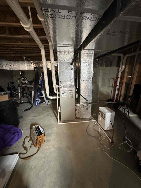 Completed estimate for replacement of 19-year-old natural gas furnace and air conditioning system located in basement mechanical room. Both units currently operational but at end of expected service life. Documented existing equipment configuration including ductwork, PVC condensate piping, and electrical connections to provide accurate replacement specifications and labor requirements.