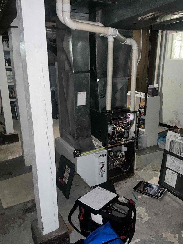 Responded to emergency service call for 32-year-old residential air conditioning system experiencing operational issues. Conducted comprehensive system evaluation and provided detailed replacement estimate for aging HVAC equipment installed in basement mechanical room. Assessment included existing furnace/air handler unit with associated PVC drainage and ventilation piping, condensate management system, and connected components showing signs of age-related deterioration requiring full system replacement recommendation.