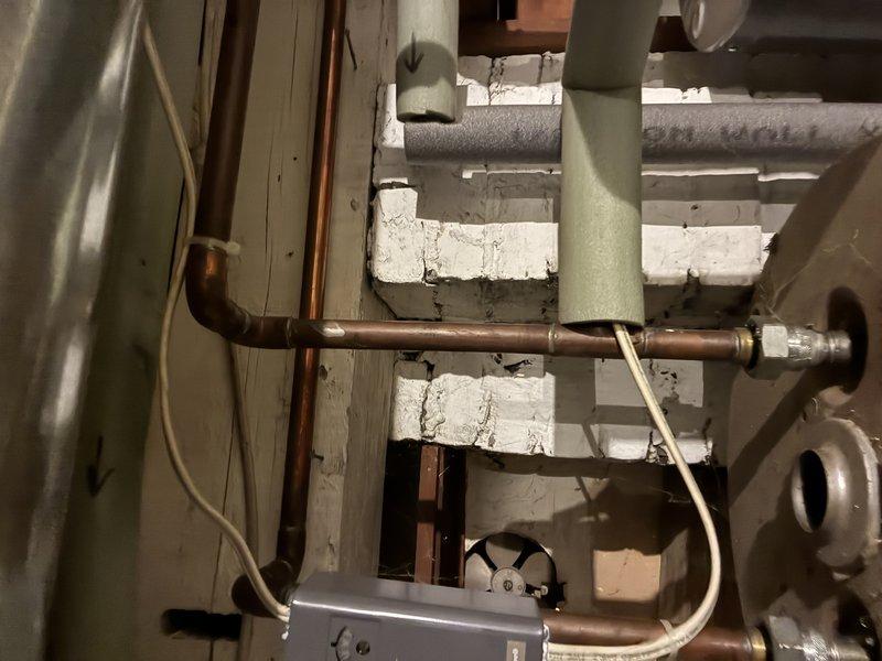 Responded to service call for temperature and pressure relief valve actively discharging water on tanked water heater system. Upon arrival, inspected water heater installation in basement utility area and confirmed T&P valve was continuously releasing water, indicating either excessive system pressure, elevated water temperature, or valve failure. Evaluated overall condition of copper supply piping, connections, and mounting configuration. Diagnosed cause of discharge issue and assessed water heater operation including temperature settings and pressure conditions. Replaced faulty T&P relief valve with new code-compliant unit, ensuring proper installation torque and orientation for safe discharge routing. Tested system operation under normal conditions to verify proper valve seating and confirmed no further water discharge occurring. System restored to safe operating condition with proper pressure relief protection in place.