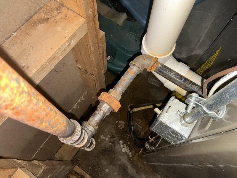 Responded to emergency furnace service call and conducted thorough assessment of existing HVAC system located in utility closet. Upon inspection, identified failed heat exchanger requiring immediate replacement due to safety concerns. Documented existing beige furnace unit with connected gray PVC ductwork and observed aged plumbing infrastructure with visible corrosion on copper piping and metal components. Provided comprehensive estimate for complete furnace replacement system to address heat exchanger failure and ensure safe, efficient operation of heating system.