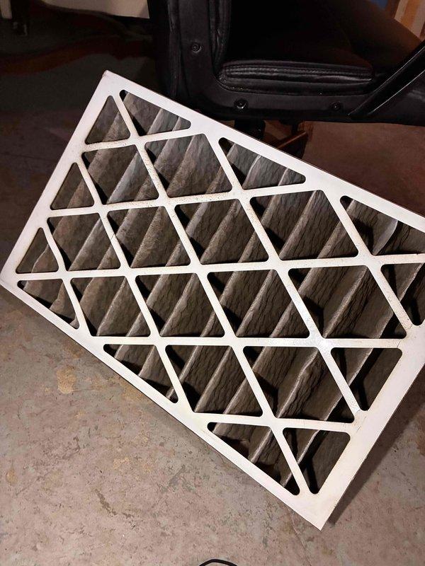 Completed comprehensive tune-up service on commercial furnace and air conditioning system, including replacement of 16x25x4 air filter which showed significant dust accumulation. During inspection, discovered deteriorated insulation material with heavy contamination requiring documentation for follow-up recommendations.