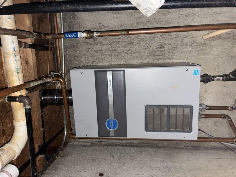 Responded to service call for non-operational water heater. Upon arrival, inspected Rinnai tankless water heating unit and associated plumbing connections. Evaluated system components including copper supply lines, ventilation assembly, and control panel to diagnose malfunction. Customer had previously contacted manufacturer regarding issue and received preliminary assessment identifying potential component failure. Performed diagnostic assessment of unit to determine repairability and provide customer with repair options versus replacement recommendations.
