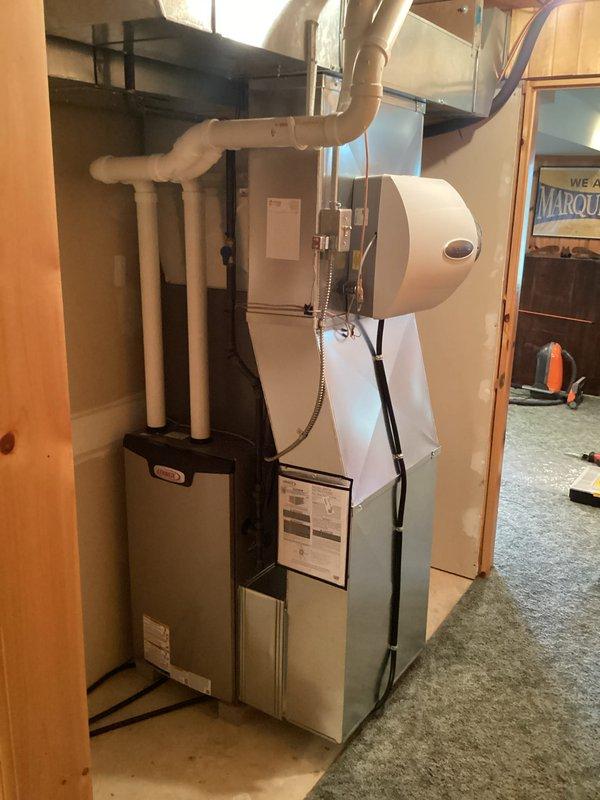Completed full HVAC system installation including new furnace, air conditioning unit, F100 media air cleaner (16x25x4), and whole-home humidifier in residential basement utility room. All work performed with proper permits and electrical connections coordinated with licensed electrician. System installed, tested, and verified operational with all components properly integrated and secured per manufacturer specifications.